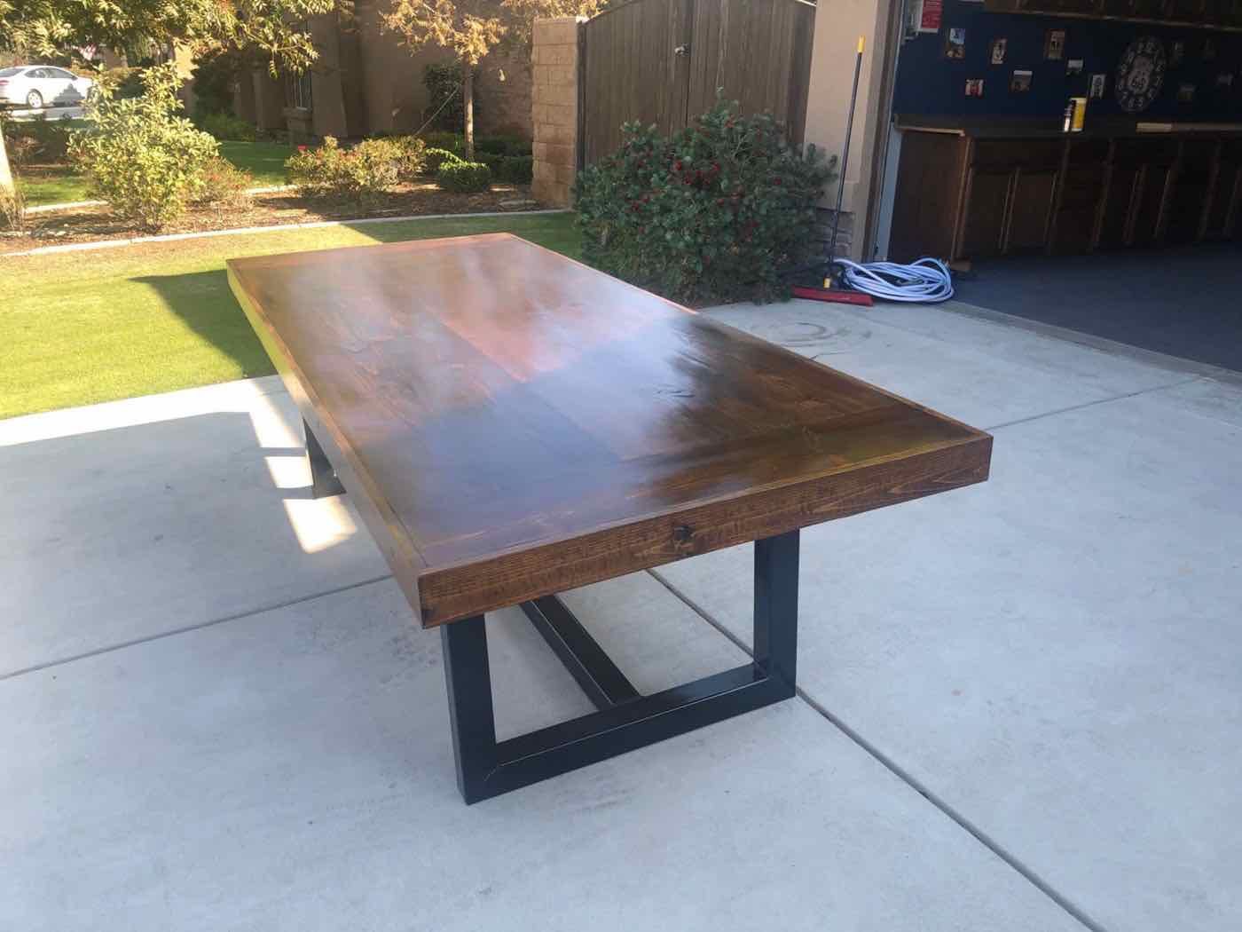 Custom conference table with a dark stained wood top and black steel legs